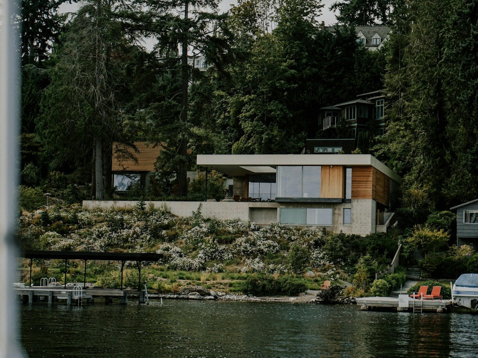 Illustrative modern Seattle home by Lake Union, surrounded by evergreens