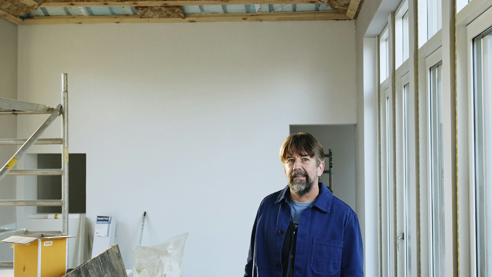 Illustrative photo of a contractor in a room under construction